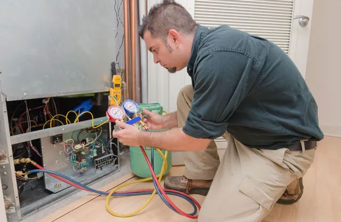 Expert worker repairing heating system