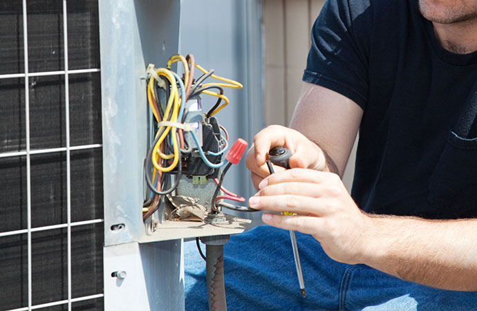 Technician repairing AC system