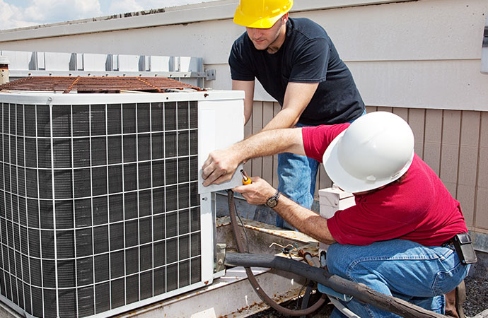 Professional worker repairing AC unit